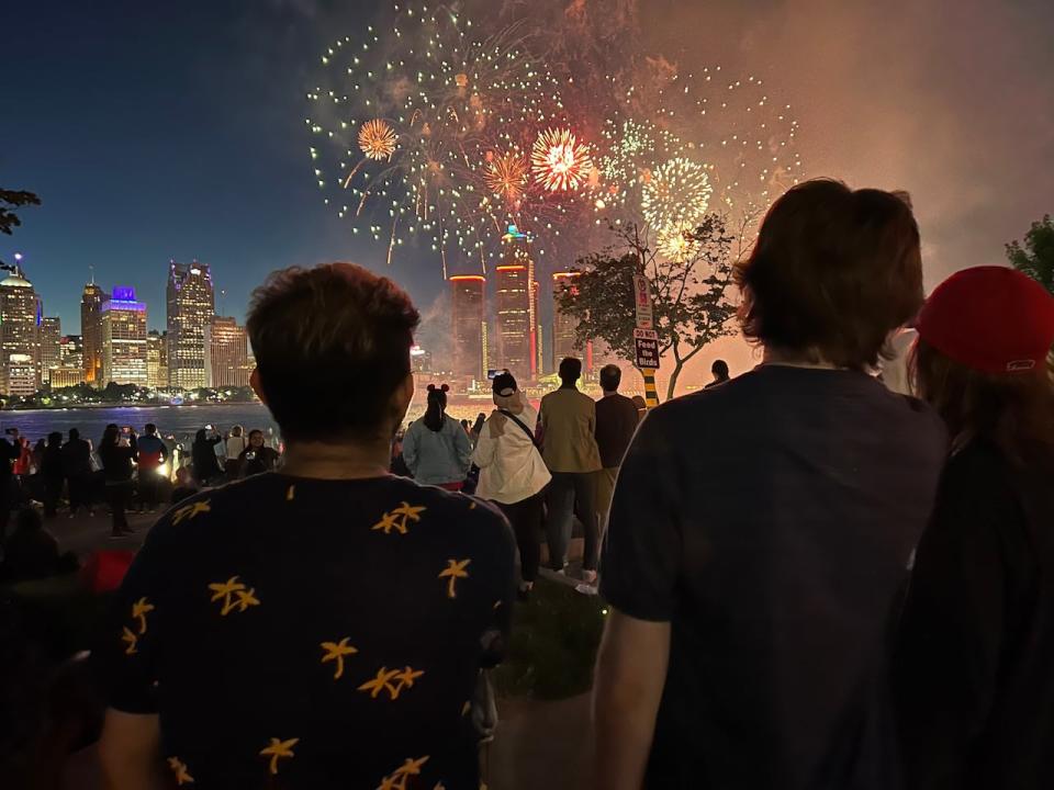 Spectators taking in the Ford Fireworks display over the Detroit River in 2022.