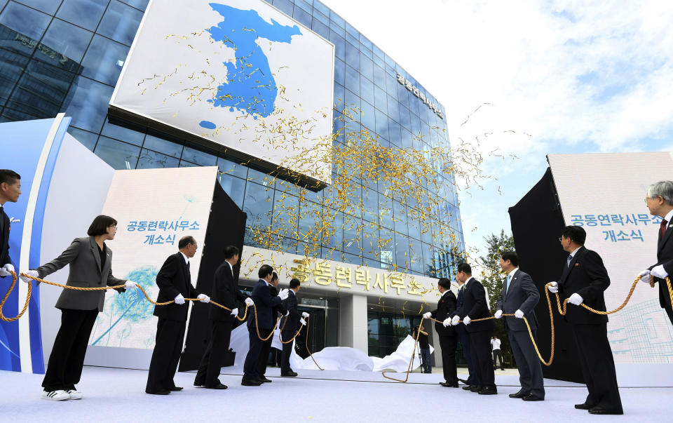 FILE - In this Sept. 14, 2018, file photo, South Korea's Unification Minister Cho Myoung-gyon, center left, and Ri Son Gwon, chairman of the North's Committee for the Peaceful Reunification, center right, attend at an opening ceremony for two Koreas' first liaison office in Kaesong, North Korea. South Korea on Tuesday, June 16, 2020, says North Korea blew up an inter-Korean liaison office amid rising tensions between the rivals. (Korea Pool/Yonhap via AP, File)