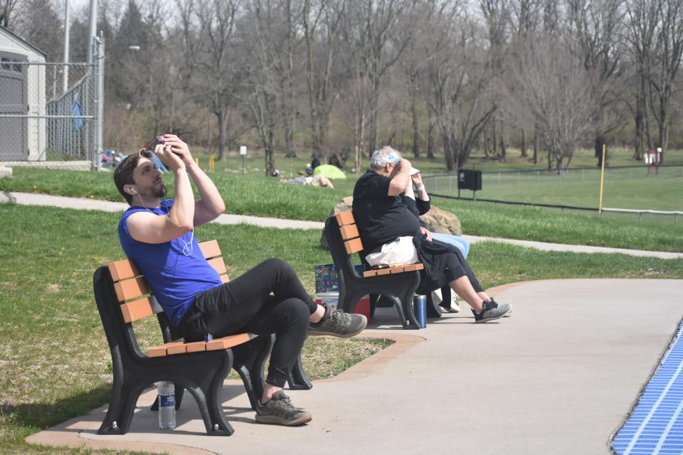 Mark Petti and Bob and Deb File are watching the nearing totality.