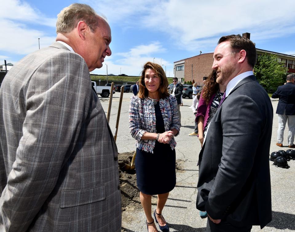 Worcester Mayor Joseph M. Petty, left, talks with Lt. Gov. Karyn Polito and Jim Lambert of Wood Partners after a groundbreaking of market-rate apartments Wednesday on the site of the former Mount Carmel Church.