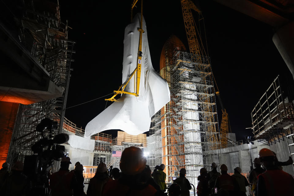 Space Shuttle Endeavour is lifted into the site of the future Samuel Oschin Air and Space Center on Tuesday, Jan. 30, 2024, in Los Angeles. (AP Photo/Ashley Landis)