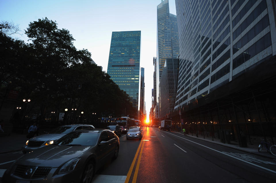 The sun sets during "Manhattanhenge" on July 12, 2011 in New York City. The Manhattan Solstice is a semiannual occurrence in which the setting sun aligns west-east with the street grid of the city. (Photo by Michael Loccisano/Getty Images)