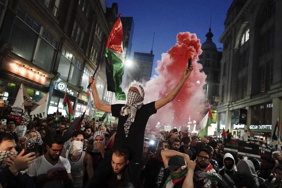 People take part in a Palestine Solidarity Campaign demonstration near the Israeli Embassy, in Kensingston, London, as the death toll rises amid ongoing violence in Israel and Gaza following the attack by Hamas, Monday, Oct. 9, 2023. (Jordan Pettitt/PA via AP)