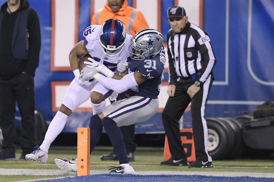 New York Giants wide receiver Golden Tate (15) comes down with a catch just in front of the goal line against Dallas Cowboys cornerback Byron Jones (31) during the second quarter of an NFL football game, Monday, Nov. 4, 2019, in East Rutherford, N.J. (AP Photo/Bill Kostroun)