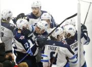 Apr 1, 2019; Chicago, IL, USA; Winnipeg Jets right wing Kevin Hayes (12) celebrates with teammates after scoring the game winning goal in overtime against the Chicago Blackhawks at United Center. Mandatory Credit: Nuccio DiNuzzo-USA TODAY Sports