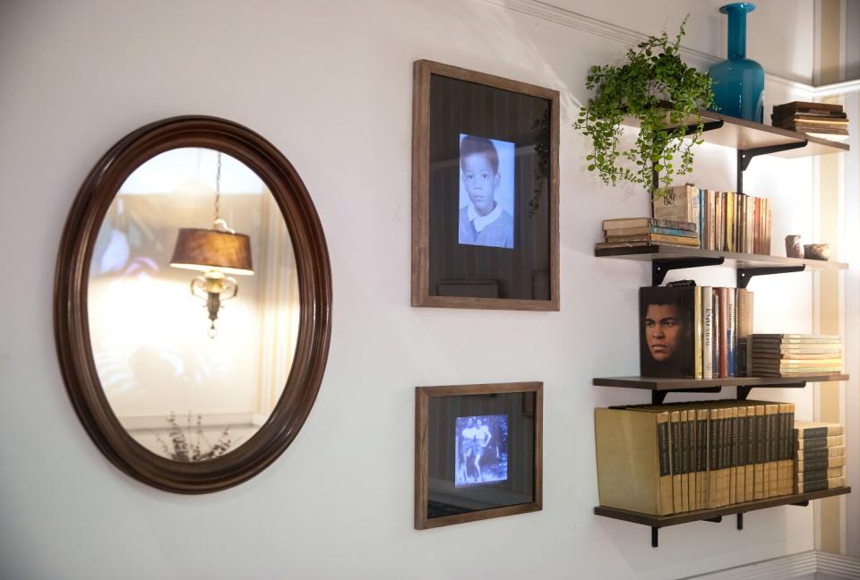 Bookshelves and family photos in a living room.