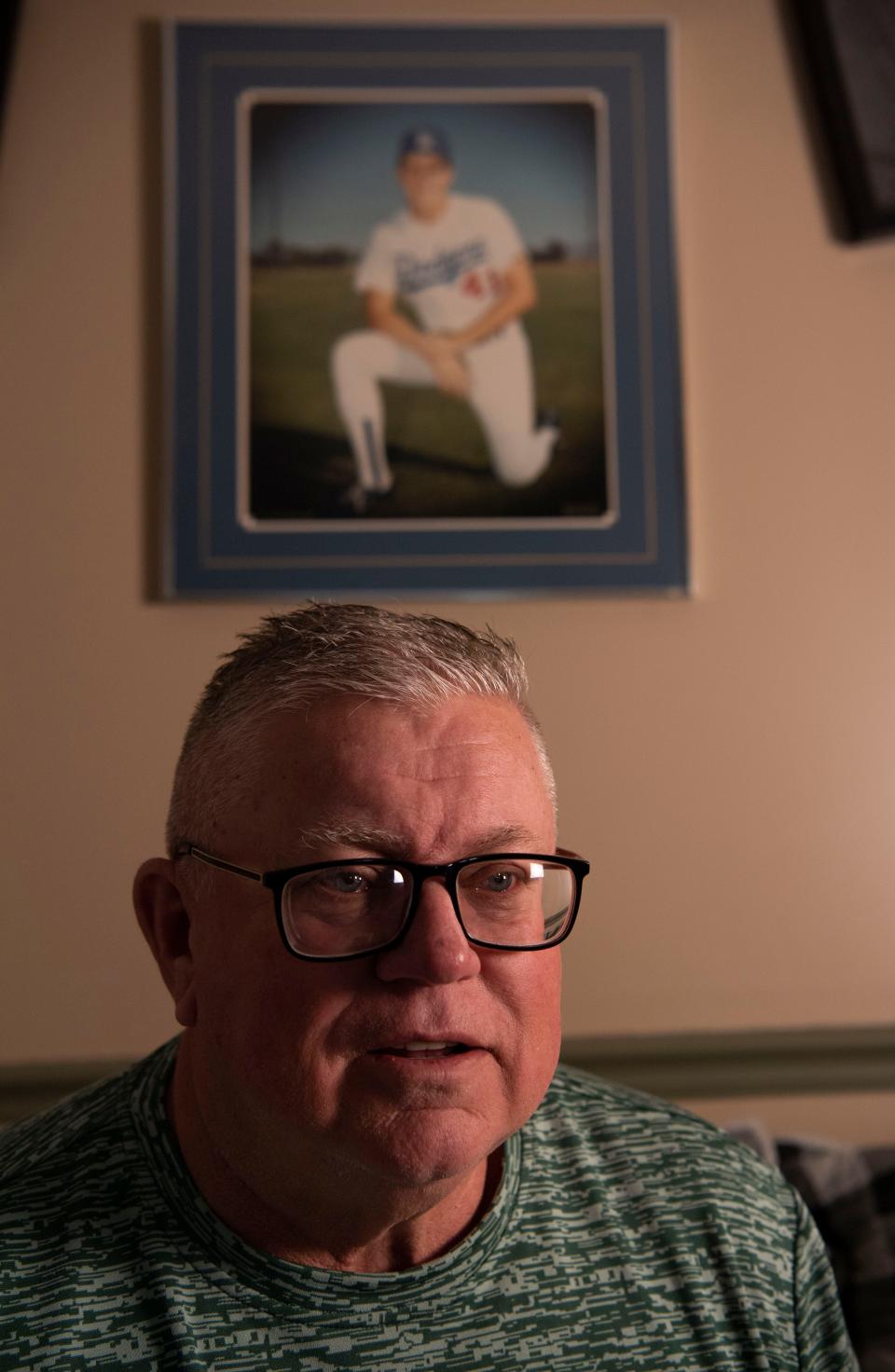 Jeff Edwards, sits in front of an old portrait of himself from when he played baseball, at his home in Mt. Juliet, Tenn., Thursday, March 28, 2024.