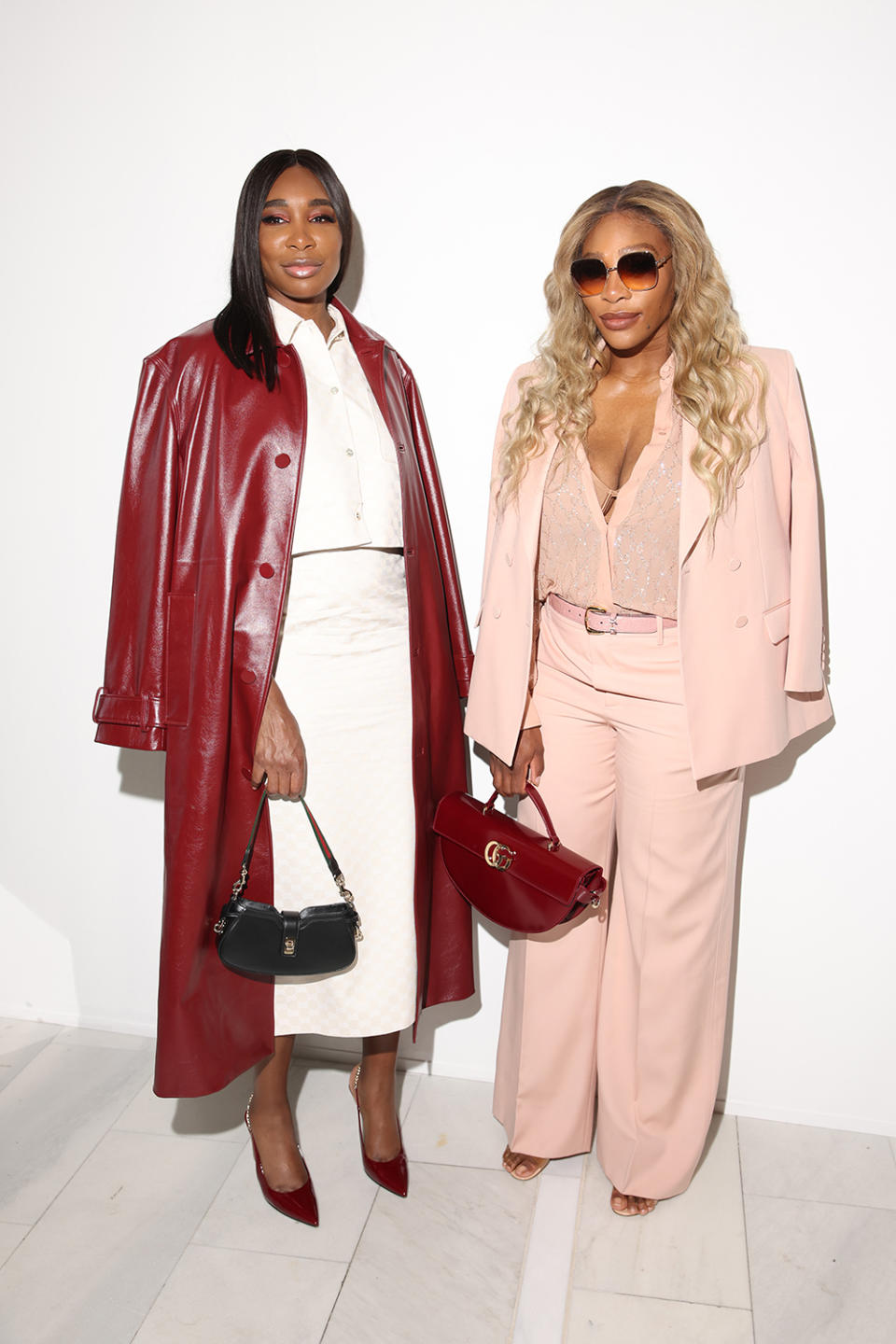 Venus Williams and Serena Williams attend the Gucci spring 2025 menswear fashion show on June 17 in Milan, front row, Ancora red, monogram