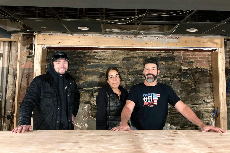 From left, Jake Baraw, Lisa Del Tufo and David Del Tufo stand inside their partially rebuilt bar Eight Oh Brew in Ludlow, Vermont, Oct. 19, 2023, three months after severe flooding in the ski town. They hope to reopen by mid-December of 2023.