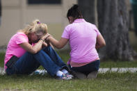 <p>Two women pray outside the family reunification site following a shooting at Santa Fe High School on Friday, May 18, 2018, in Santa Fe, Texas. (Photo: Marie D. De Jesus /Houston Chronicle via AP) </p>