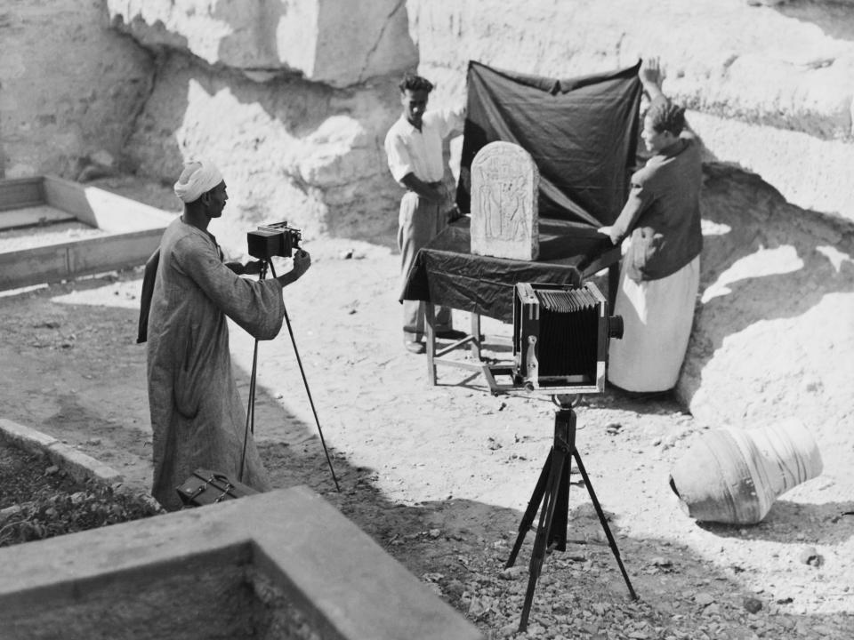 Archaeologists photographing an ancient Egyptian funerary stele, Egypt, circa 1925.