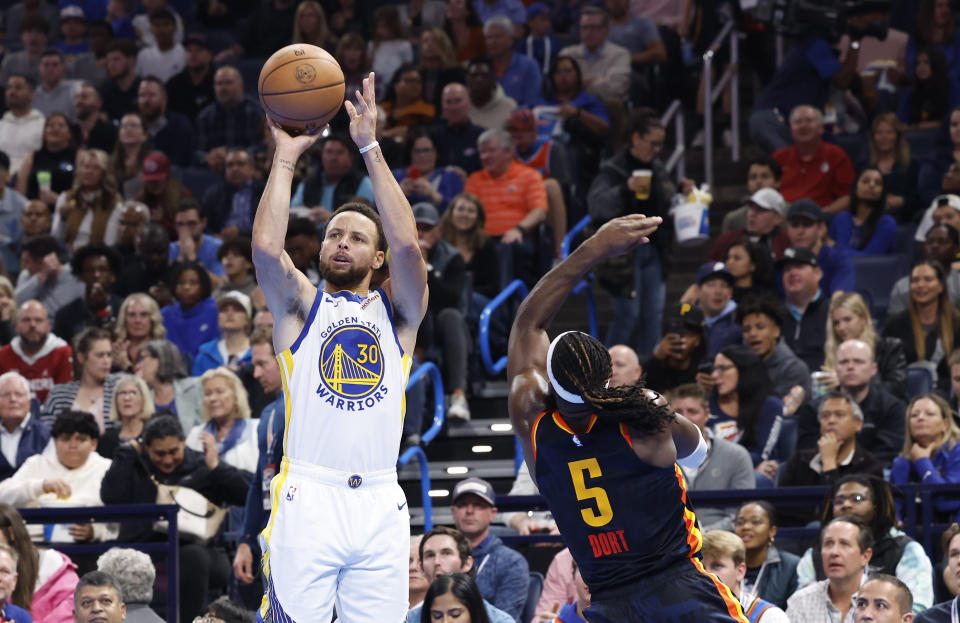 Nov 3, 2023; Oklahoma City, Oklahoma, USA; Golden State Warriors guard Stephen Curry (30) shoots a thee point basket against Oklahoma City Thunder guard Luguentz Dort (5) during the second half at Paycom Center. Mandatory Credit: Alonzo Adams-USA TODAY Sports