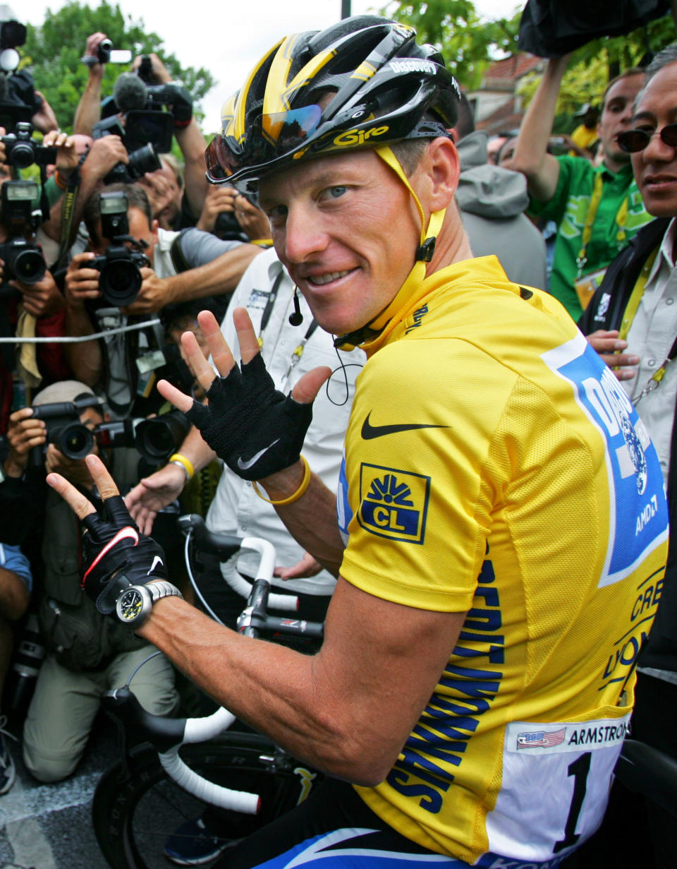 FILE - In this July 24, 2005, file photo, Lance Armstrong gestures for his seventh straight win in the Tour de France cycling race before the final stage between Corbeil-Essonnes, south of Paris, and the French capital. In 2005, Armstrong was also named Associated Press Male Athlete of the Year and ESPN's ESPY Award for Best Male Athlete. He later announced what would be a temporary retirement from cycling in 2005. (AP Photo/Peter Dejong, File)