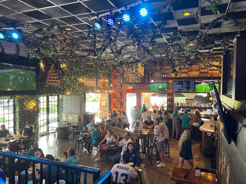 Miami Dolphins and NFL fans watch the Miami-Kansas City game on the TVs at Biergarten restaurant in Boca Raton Sunday morning.