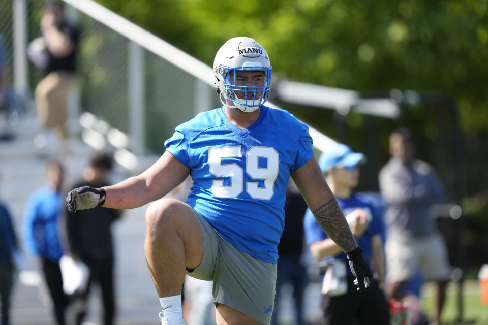 Detroit Lions offensive lineman Giovanni Manu stretches during an NFL rookie football practice, Friday, May 10, 2024, in Allen Park, Mich. (AP Photo/Carlos Osorio)