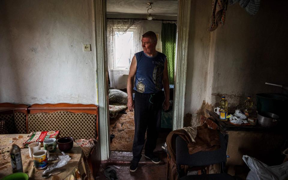 A Vilkhivka resident inspects his house following the withdrawal of Russian forces - Dimitar Dilkoff/AFP via Getty Images