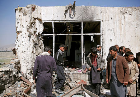 People inspect a damaged shop at the site of a blast in Kabul, Afghanistan March 17, 2018. REUTERS/Mohammad Ismail