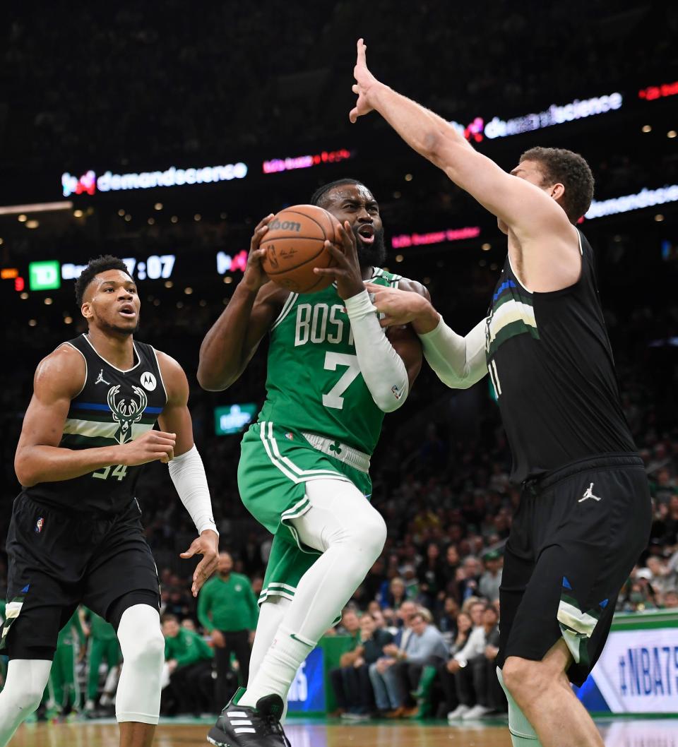 Celtics guard Jaylen Brown drives to the basket while Bucks center Brook Lopez defends Tuesday night.