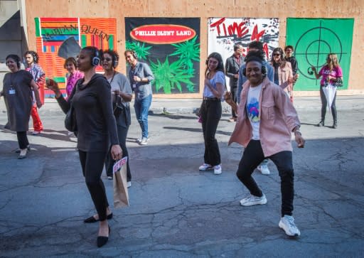 The dance work sees visitors don headphones and join a choreographed line dance