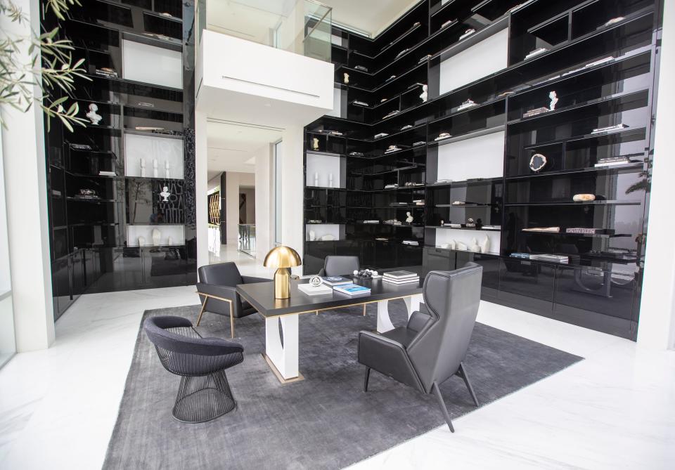 black shelves and gray chairs in a room in mansion The One Bel Air