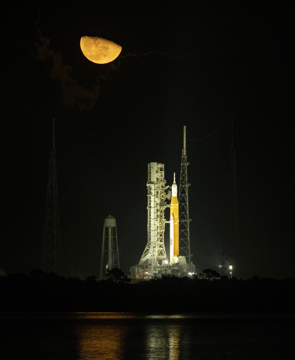 The moon rises above NASA's Space Launch System (SLS) rocket with the Orion spacecraft aboard at Launch Pad 39B as preparations for launch continue, Monday, Nov. 14, 2022, at NASA's Kennedy Space Center in Florida. (NASA/Bill Ingalls)