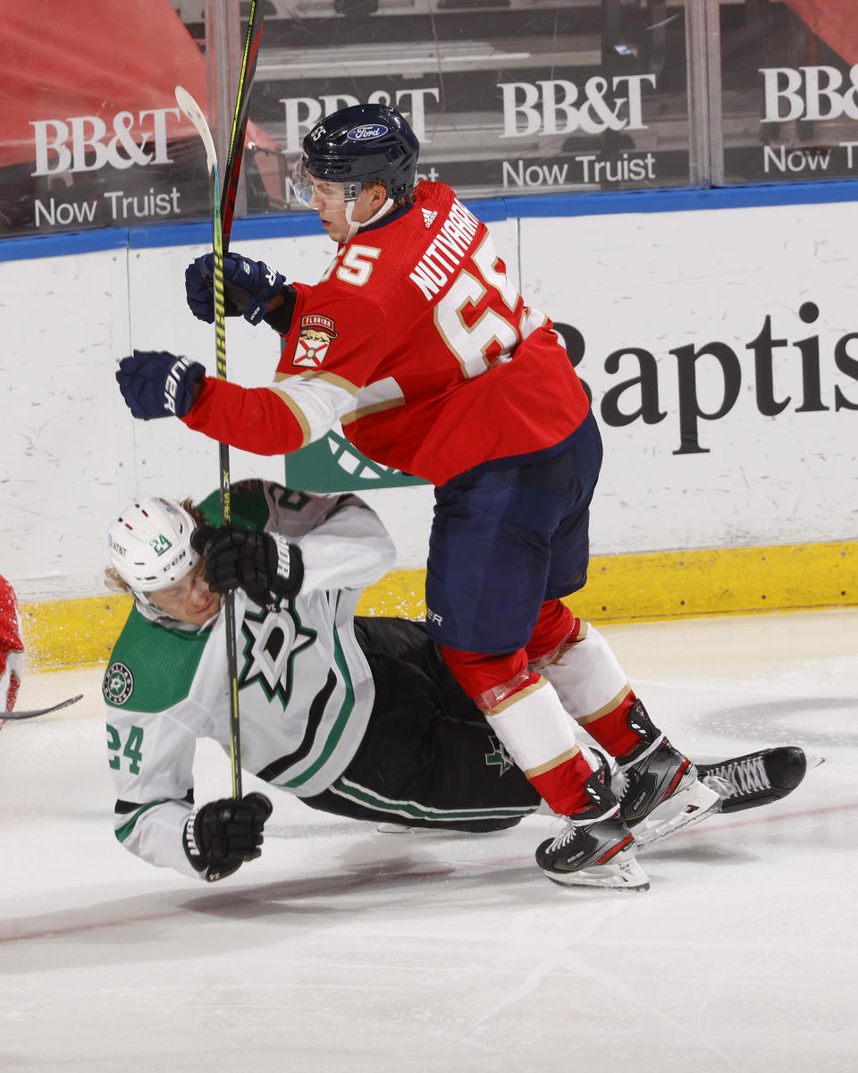 Florida Panthers defenseman Markus Nutivaara (65) takes Dallas Stars left wing Roope Hintz (24) to the ice during the second period of an NHL hockey game, Monday, May 3, 2021, in Sunrise, Fla. (AP Photo/Joel Auerbach)