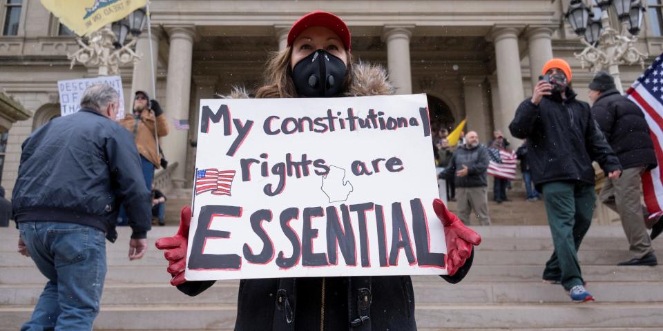 Hundreds of demonstrators protested against Michigan's extended stay-at-home order at the Capitol building in Lansing on April 15, 2020.