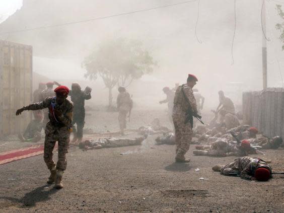 Soldiers lie on the ground after a missile attack on a military parade during a graduation ceremony for newly recruited troopers in Aden, Yemen (Reuters)