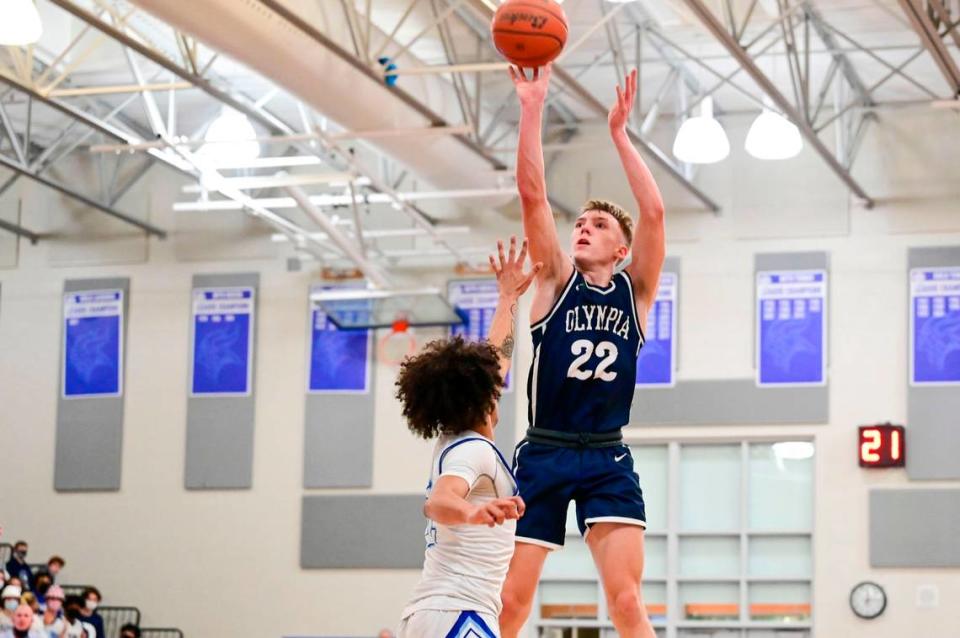 Olympia guard Parker Gerrits (22) attempts a shot as Curtis guard Gabe Martin (2) defends during the second quarter of a 4A South Puget Sound League game on Friday, Jan. 21, 2022, at Curtis High School in University Place, Wash.