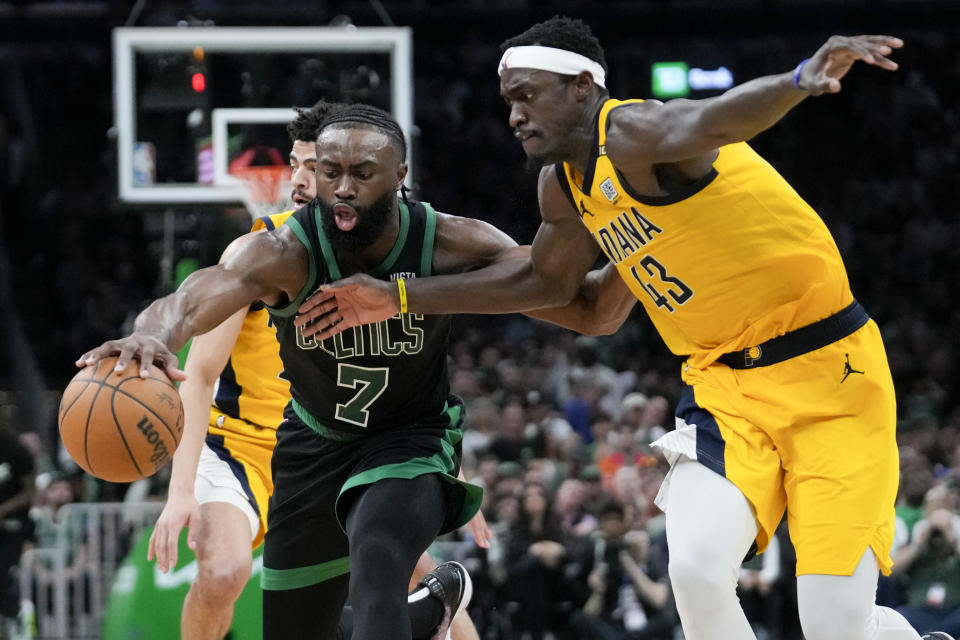 Boston Celtics guard Jaylen Brown (7) is defended by Indiana Pacers forward Pascal Siakam (43) during the second half of Game 2 of the NBA Eastern Conference basketball finals Thursday, May 23, 2024, in Boston. (AP Photo/Steven Senne)