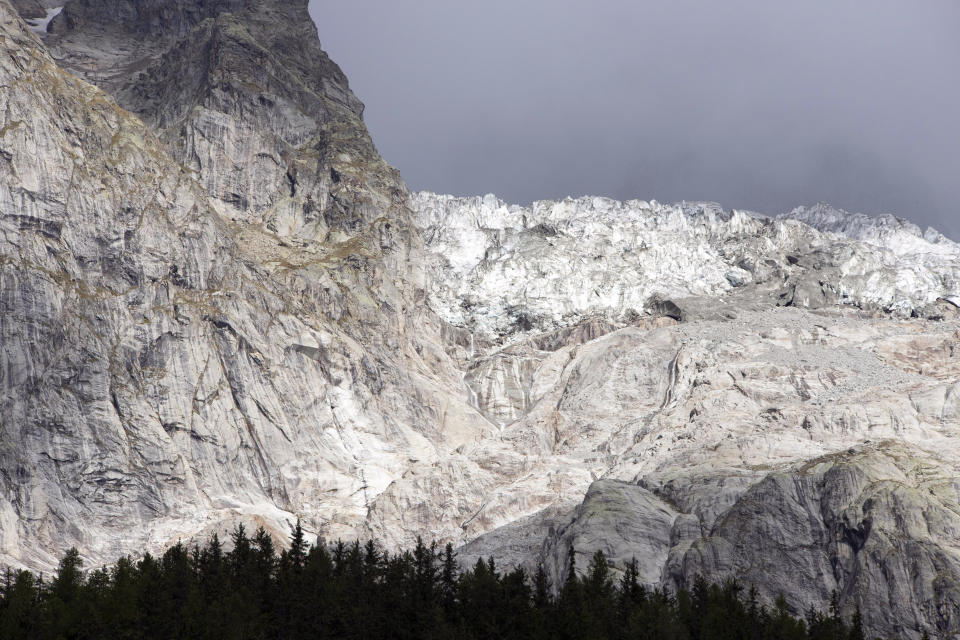 In this picture made available Thursday, Sept. 26, 2019, the Planpincieux glacier, top, located in the Alps on the Grande Jorasses peak of the Mont Blanc massif, is seen from Val Ferret, a popular hiking area on the south side of the Mont Blanc, near Courmayeur, northern Italy, Wednesday, Sept. 25, 2019. Italian officials sounded an alarm Wednesday over climate change due to the threat that the fast-moving melting glacier is posing to the picturesque valley near the Alpine town of Courmayeur, the glacier, which spreads 1,327 square kilometers (512 square miles) across the mountain, has been moving up to 50 centimeters (nearly 20 inches) a day. (Moreno Vignolini, Fondazione Montagna Sicura via AP)