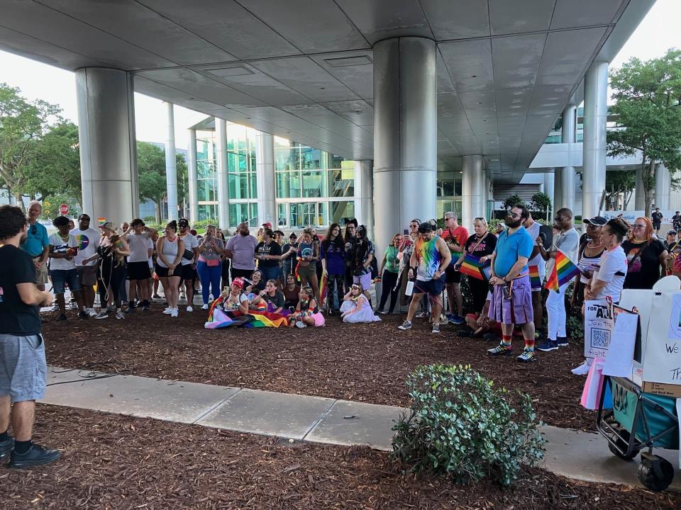 Hundreds of people carrying glow sticks gleaming the rainbow colors of the LGBTQ+ Pride flag gathered to march across the Acosta Bridge in a peaceful demonstration Saturday night, June 29, 2024, to raise awareness and show support for the LGBTQ+ community.