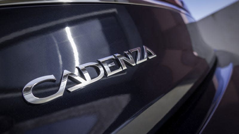 A photo of the Cadenza name badge on the back of a Kia. 