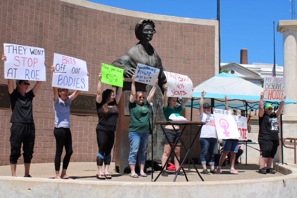Protesters display signs advocating for abortion access and reproductive rights during a demonstration Saturday, July 9, 2022 at the Sojourner Truth Monument in Battle Creek, Michigan.