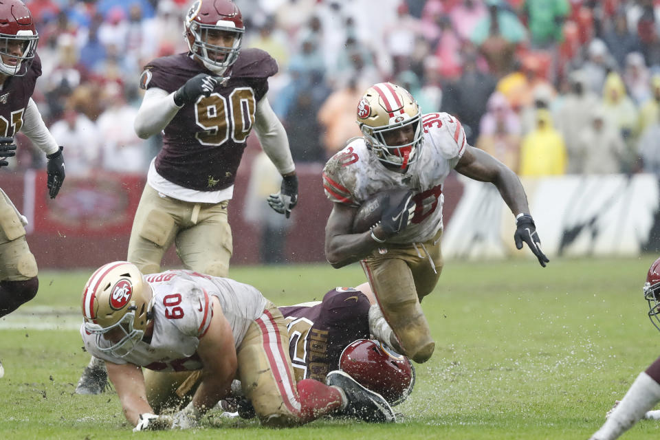 Oct 20, 2019; Landover, MD, USA; San Francisco 49ers running back Jeff Wilson (30) is tackled by Washington Redskins linebacker Cole Holcomb (55) while carrying the ball in the fourth quarter at FedExField. Mandatory Credit: Geoff Burke-USA TODAY Sports