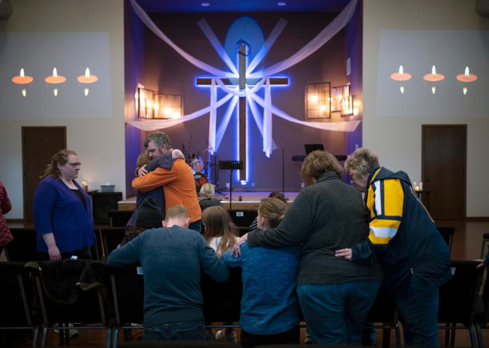 Relatives of Lily Peters comfort each other at the vigil (AP)