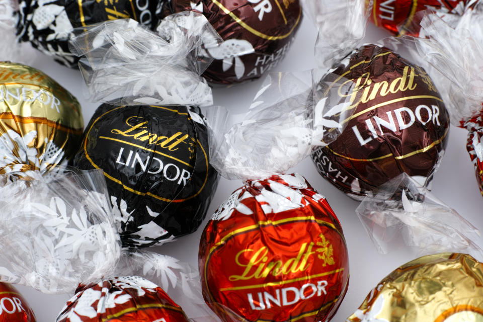 Tambov, Russian Federation - March 08, 2015: Lindt Lindor chocolate truffles on white background. Lindor assorted balls: the Lindt milk, dark and white chocolate candies. Studio shot.