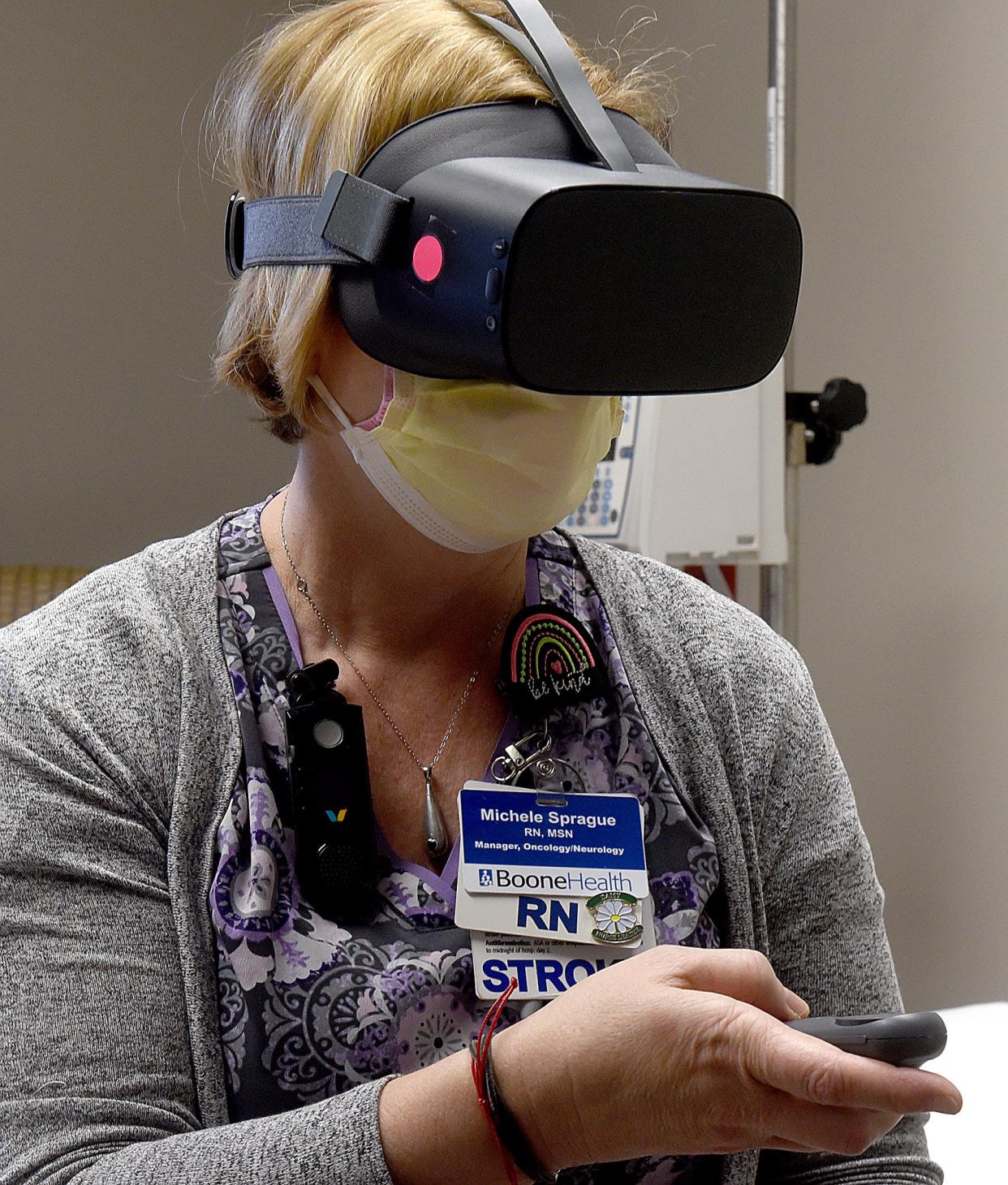 Boone Health nurse manager Michele Sprague displays a virtual reality headset on Monday used by hospital staff in a study about reducing stress levels of health care workers.