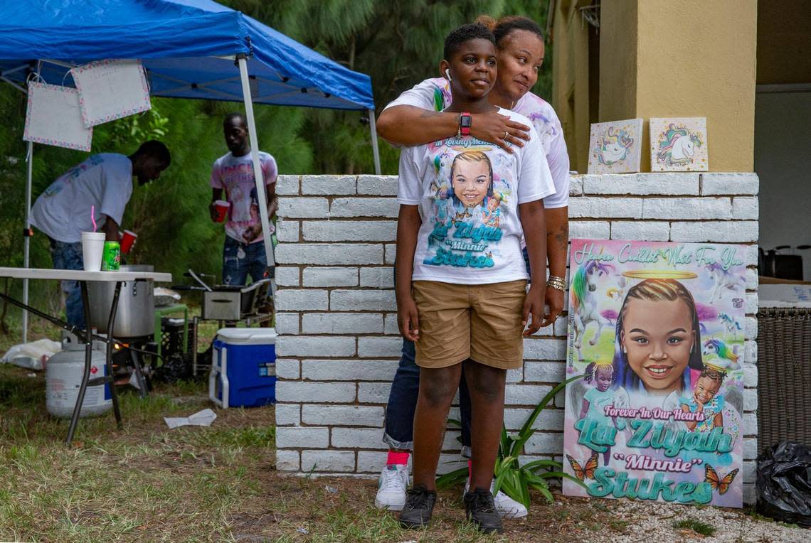 Seven months after a tragic hit-and-run that killed Laziyah Stukes,10, two other girls and left several children injured, Stukes mother, Devera Stukes, holds a balloon release and fish fry to help raise money to pay for her daughter’s funeral. Devera Stukes stands with her godson Johnathan Carter, 11, stand by a poster of Laziyah “Minnie” Stukes, as family and friends gather at the Fort Lauderdale home on Saturday, July 16, 2022.