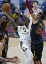 Indiana Pacers' Edmond Sumner (5) shoots over Cleveland Cavaliers' Isaac Okoro (35) during the second half of an NBA basketball game Wednesday, March 3, 2021, in Cleveland. (AP Photo/Tony Dejak)