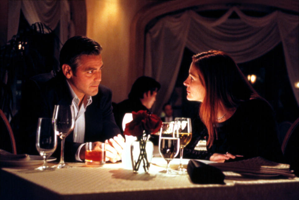 George Clooney and Julia Roberts sit at a dinner table together