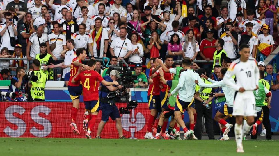 Spain players celebrate their victory against Germany