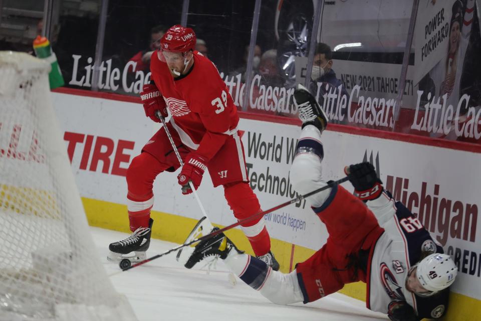 Detroit Red Wings right wing Anthony Mantha (39) defends against Columbus Blue Jackets center Ryan MacInnis (49) during first period action Sunday, March 28, 2021 at Little Caesars Arena in Detroit.