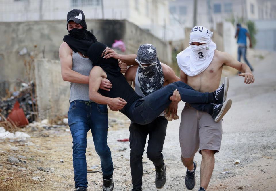 Carrying a comrade during West Bank clashes