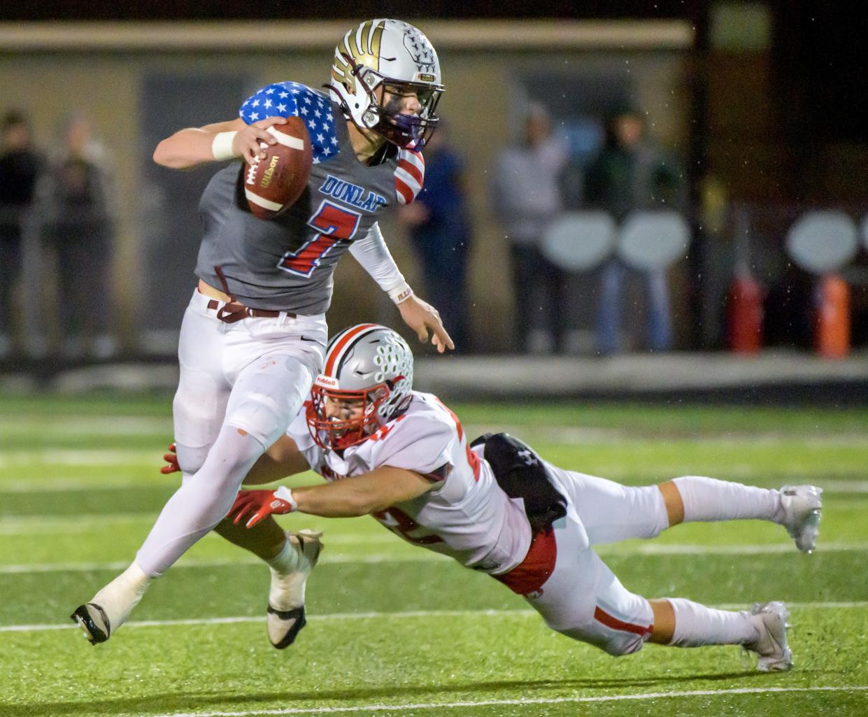 Dunlap quarterback Mack Sutter (7) tries to escape Morton's Trae Erickson in the second half of their Week 8 football game Friday, Oct. 13, 2023 at Dunlap High School.