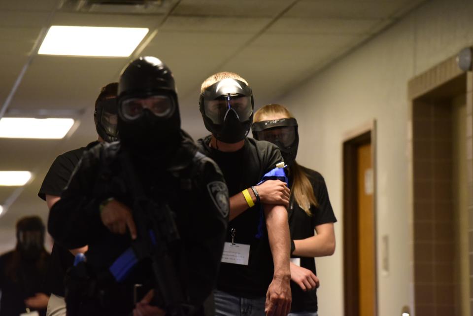 Port Huron Police Department officers guide an injured civilian out of the building during the active killer training on the campus of St. Clair County Community College in Port Huron on Tuesday, August 9, 2022.