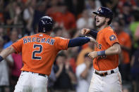 Houston Astros' Kyle Tucker, right, celebrates with Alex Bregman after hitting a grand slam against the Oakland Athletics during the fifth inning of a baseball game Friday, Aug. 12, 2022, in Houston. (AP Photo/Kevin M. Cox)