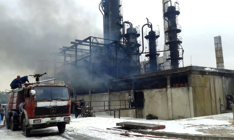 Firefighters try to put out a fire in main Homs refinery