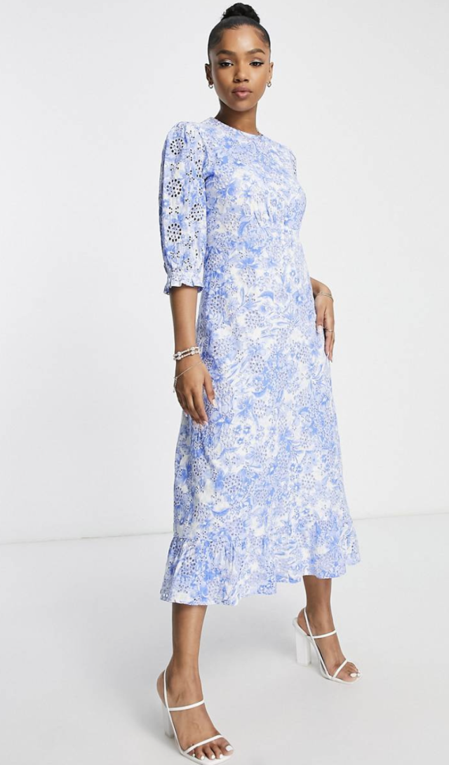 model wearing white strappy heel sandals and light blue and white floral Nobody&#39;s Child Selena Floral Print Midi Dress (Photo via ASOS)