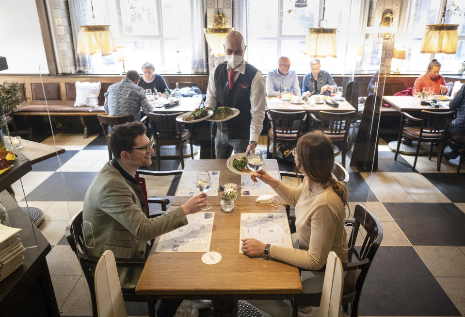 Linus and Regina are served lunch at the Grosser Kiepenkerl in Muenster, Germany, as restaurants are allowed to open due to the city's low corona infections rate on Friday, May 21, 2021. (Bernd Thissen/dpa via AP)